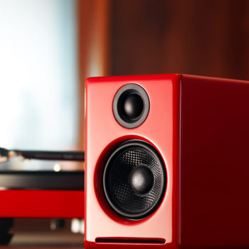 Lifestyle photo of red Audioengine 2+ powered speakers